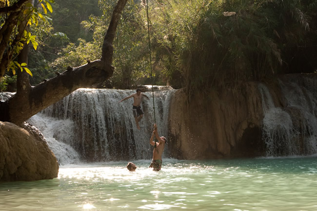 People swimming in a pool of Kuang Si Waterfall