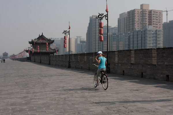 Heidi bicycling on the Xi' An city wall