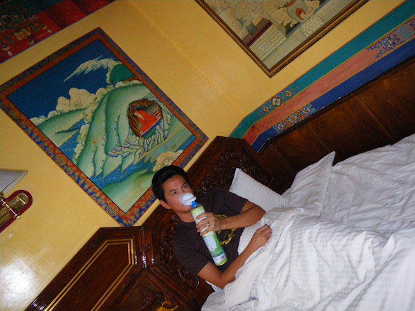George breathing in a can of oxygen, Lhasa, Tibet