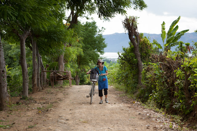 Heidi Pushing her Bicycle up the Hill Toward the Forest Monastery